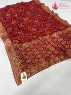 pallu detailing of red soft georgette bandhani saree