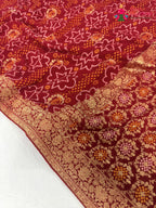 close up detailing of red soft georgette bandhani saree