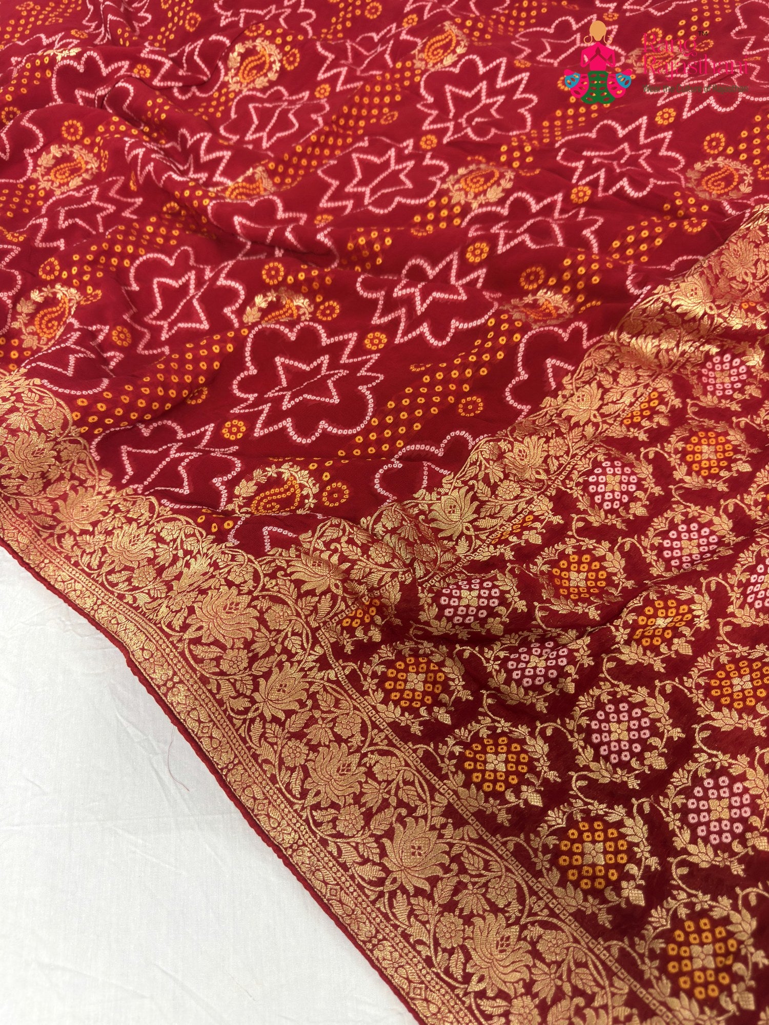 close up detailing of red soft georgette bandhani saree