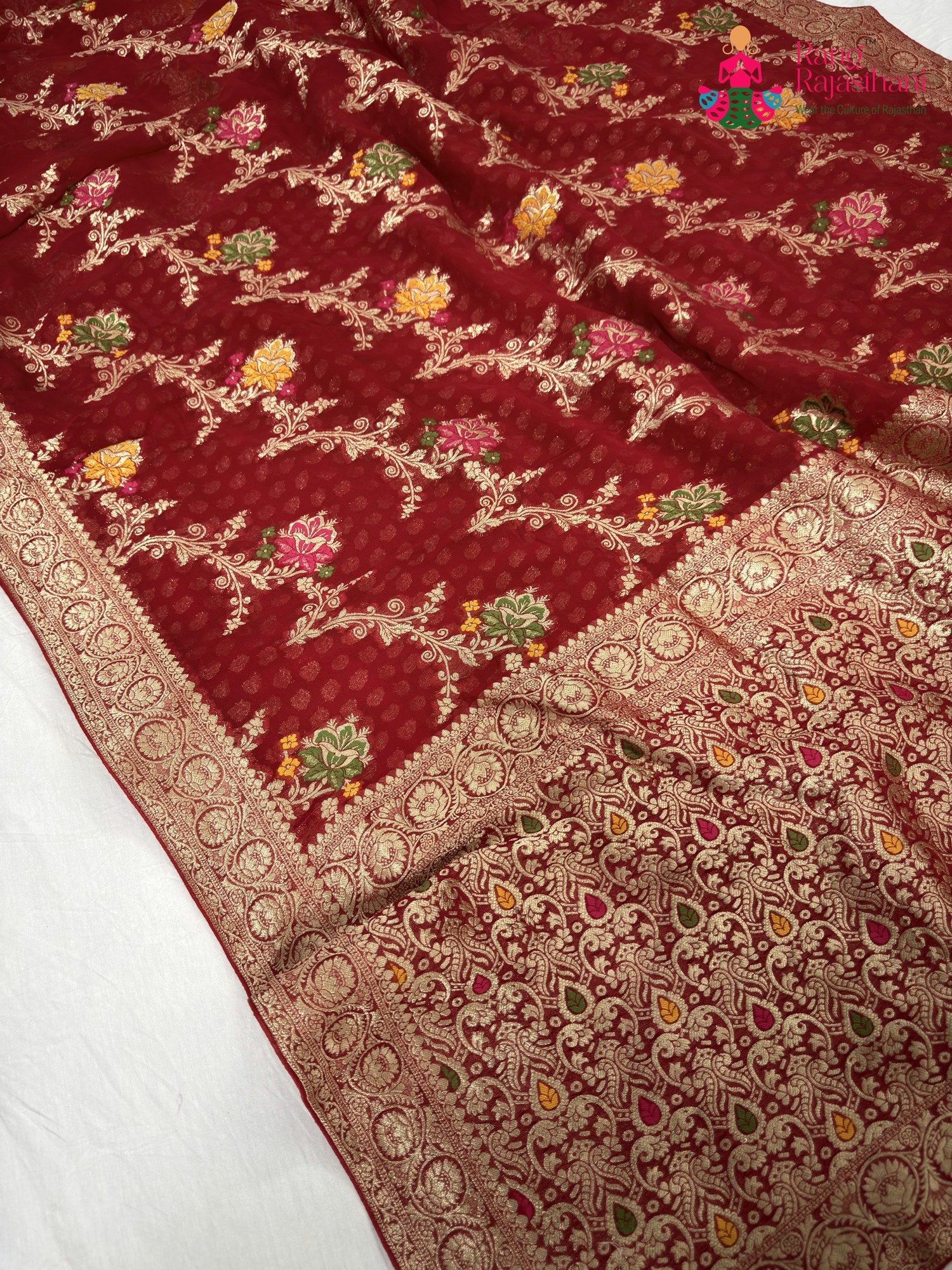 pallu detailing of red soft georgette meenakari zari saree
