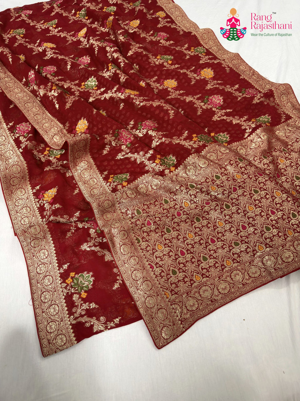 close up detailing of red soft georgette meenakari zari saree