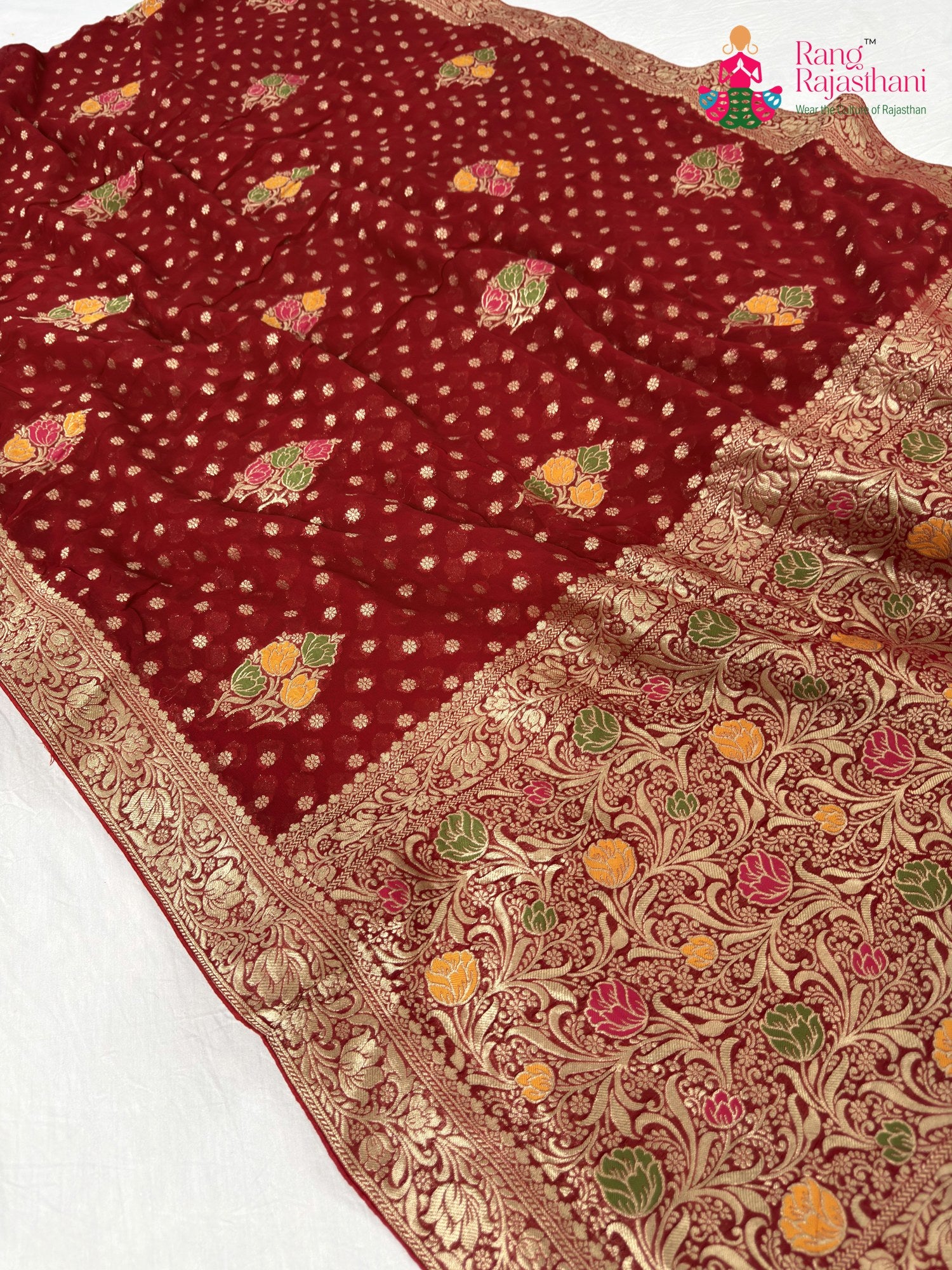 pallu detailing of red soft georgette meenakari zari saree