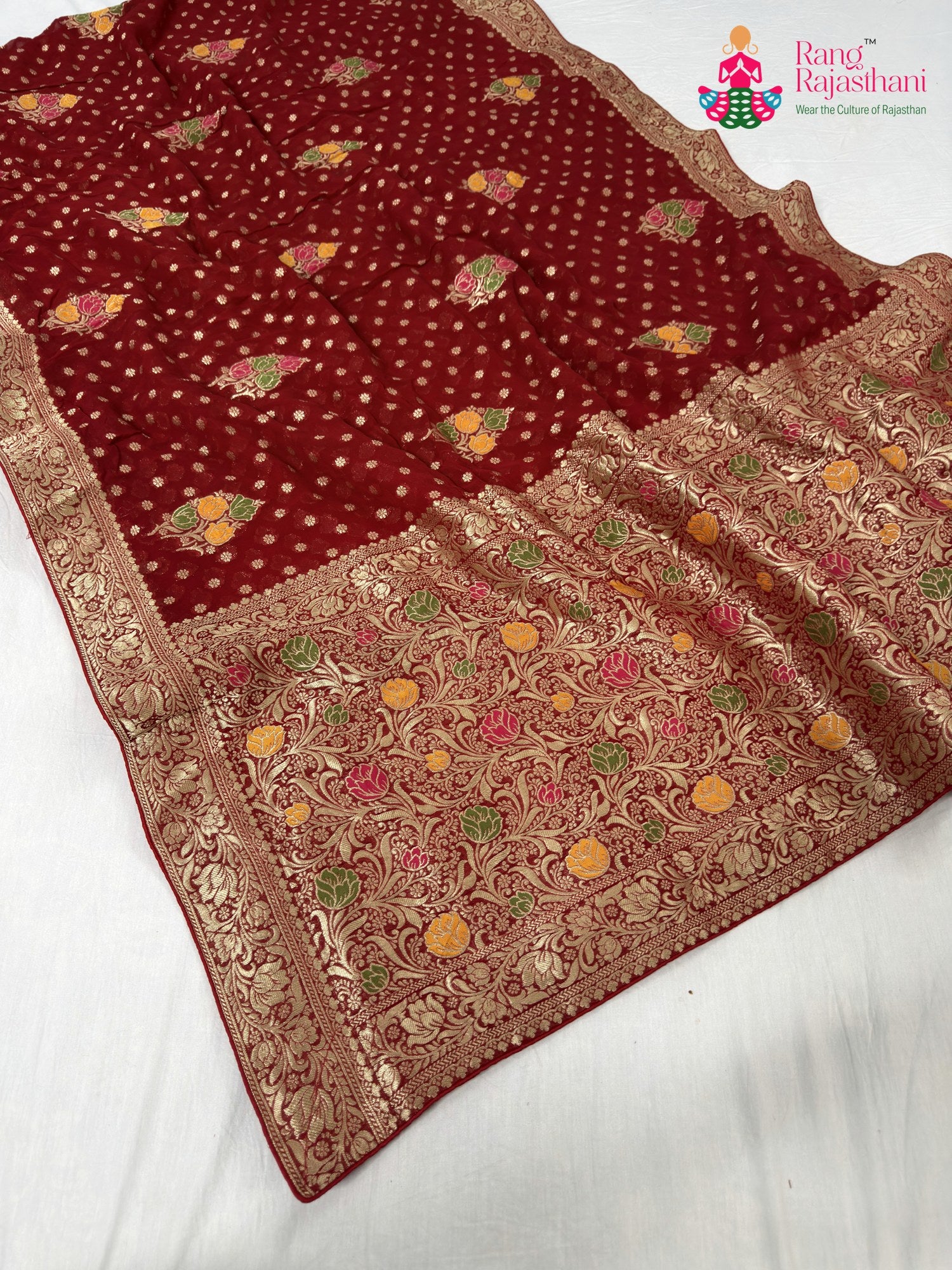 close up detailing of red soft georgette meenakari zari saree