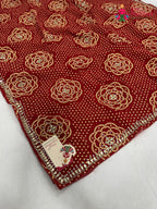 close up detailing of red synthetic bandhani saree
