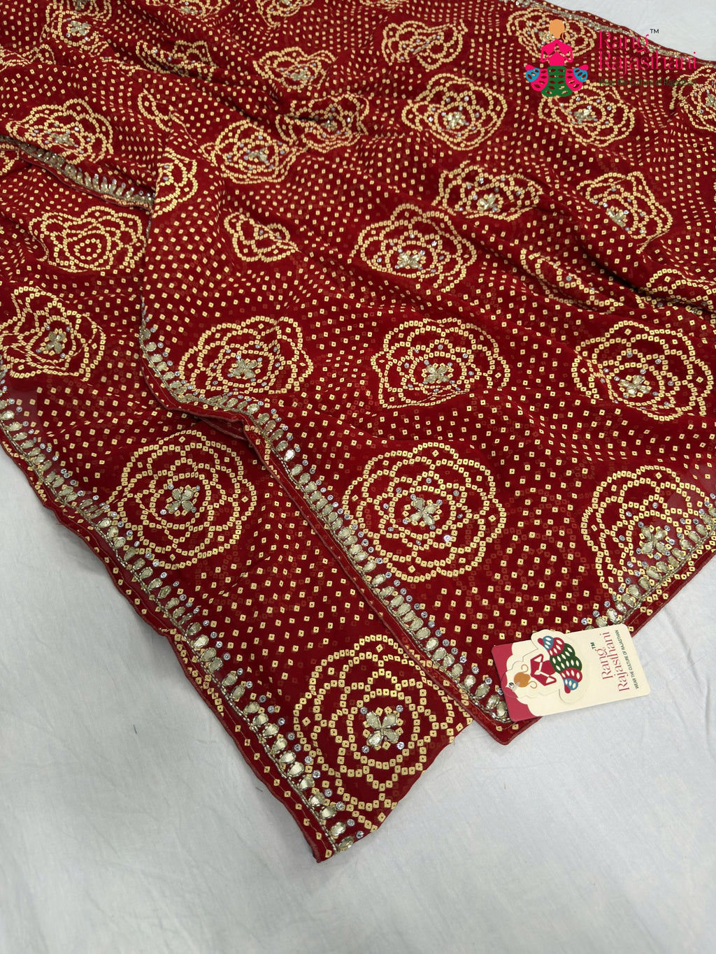 border detailing of red synthetic bandhani saree