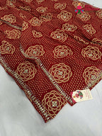 border detailing of red synthetic bandhani saree