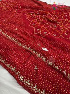 close up detailing of red synthetic bandhani saree