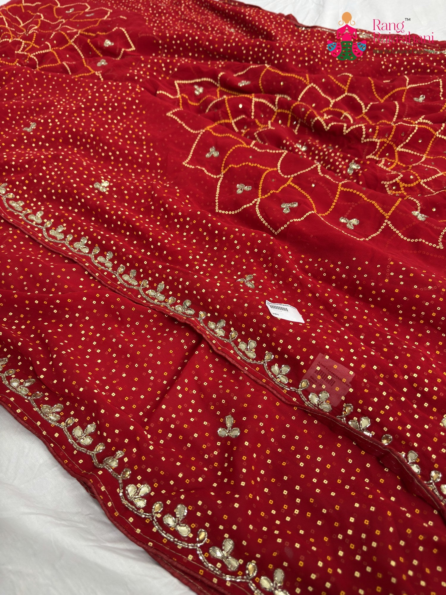 close up detailing of red synthetic bandhani saree