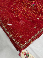 border detailing of red synthetic bandhani saree