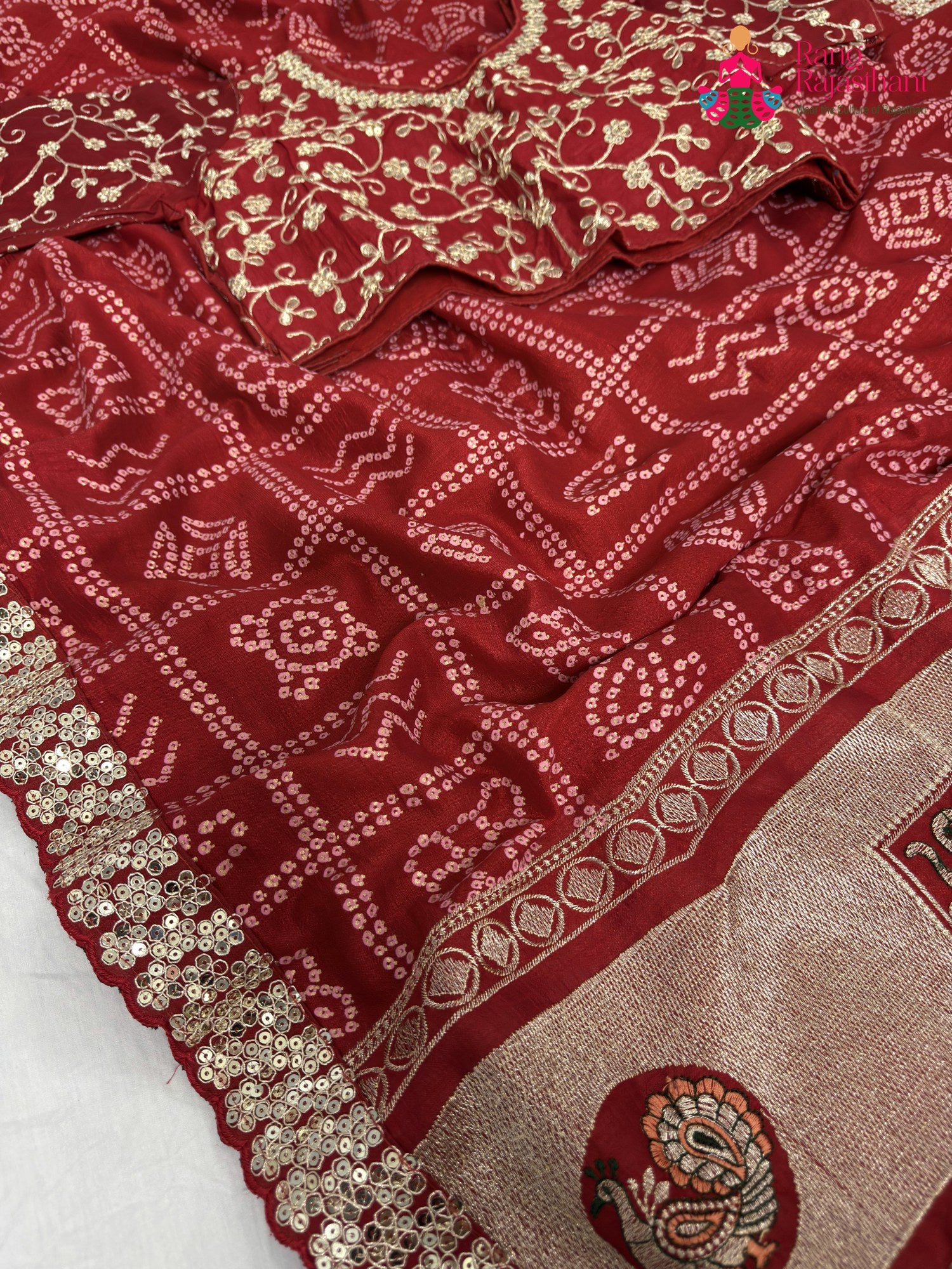 close up detailing of red synthetic zari embroidery saree