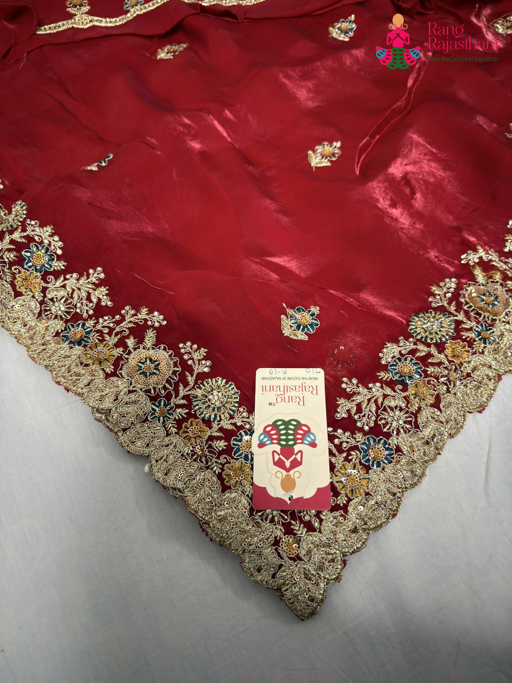 close up detailing of red synthetic zari embroidery saree