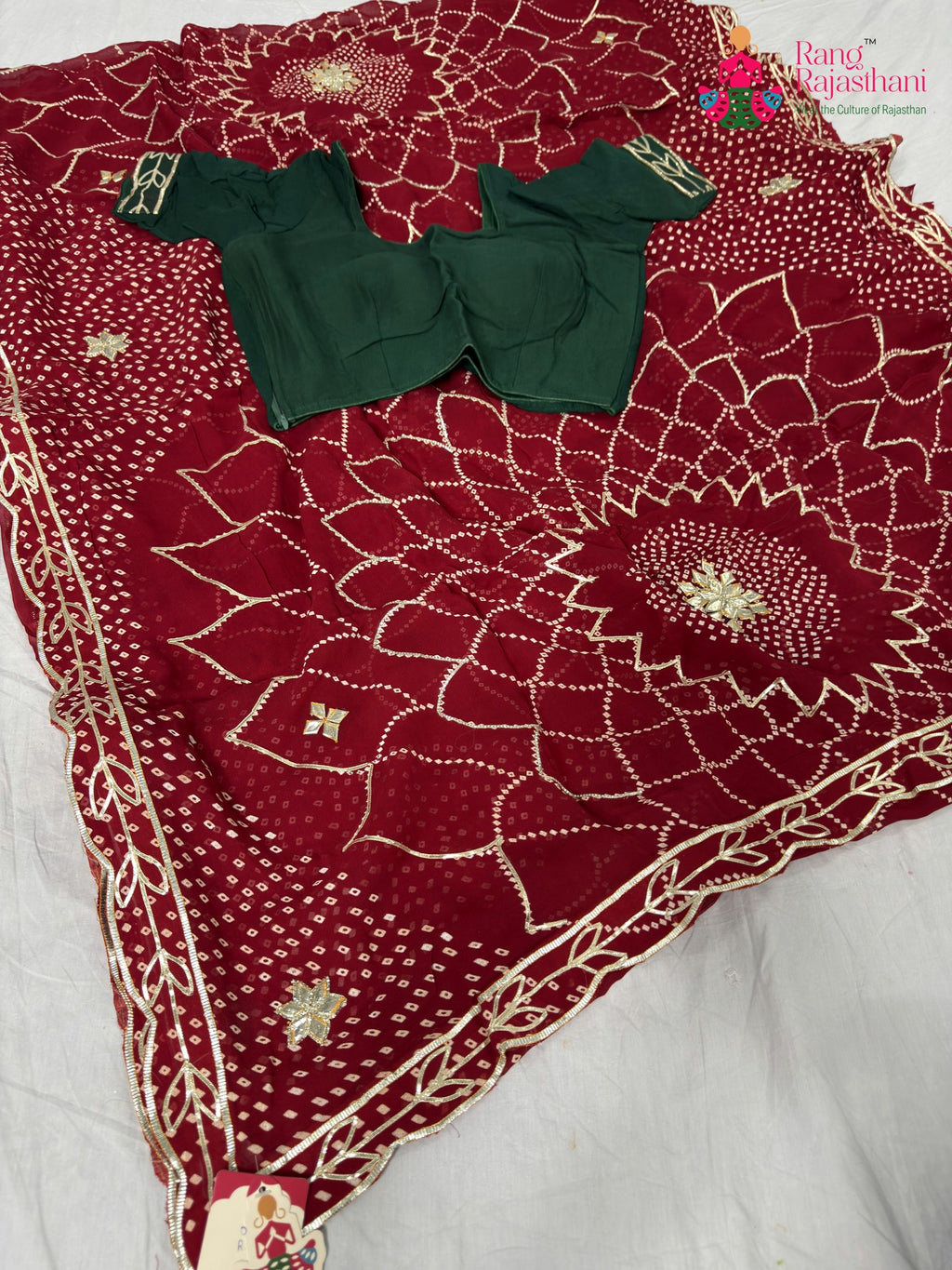 border detailing of soft red fabric saree