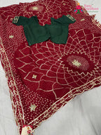 border detailing of soft red fabric saree