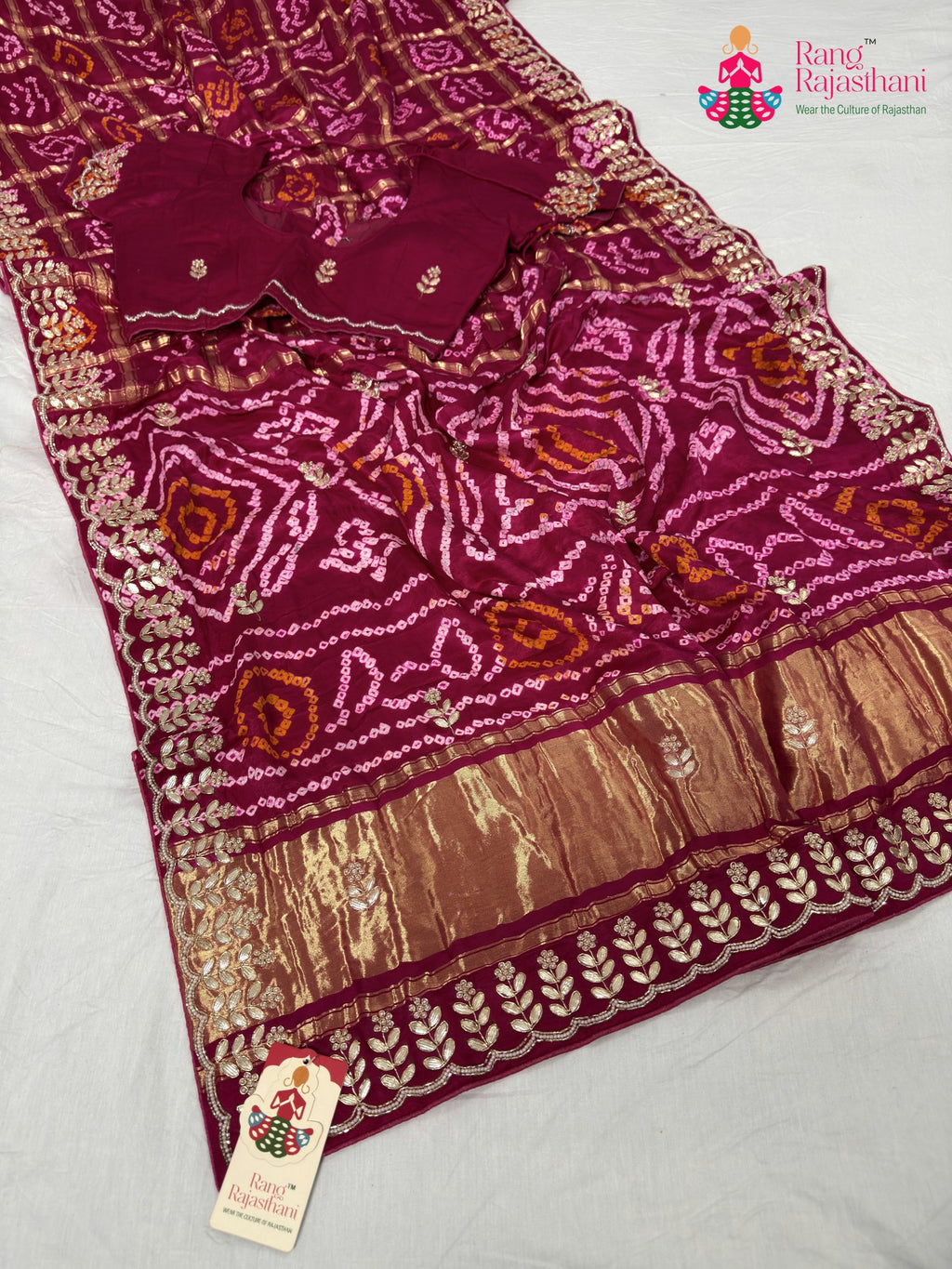 border detailing of soft red fabric saree