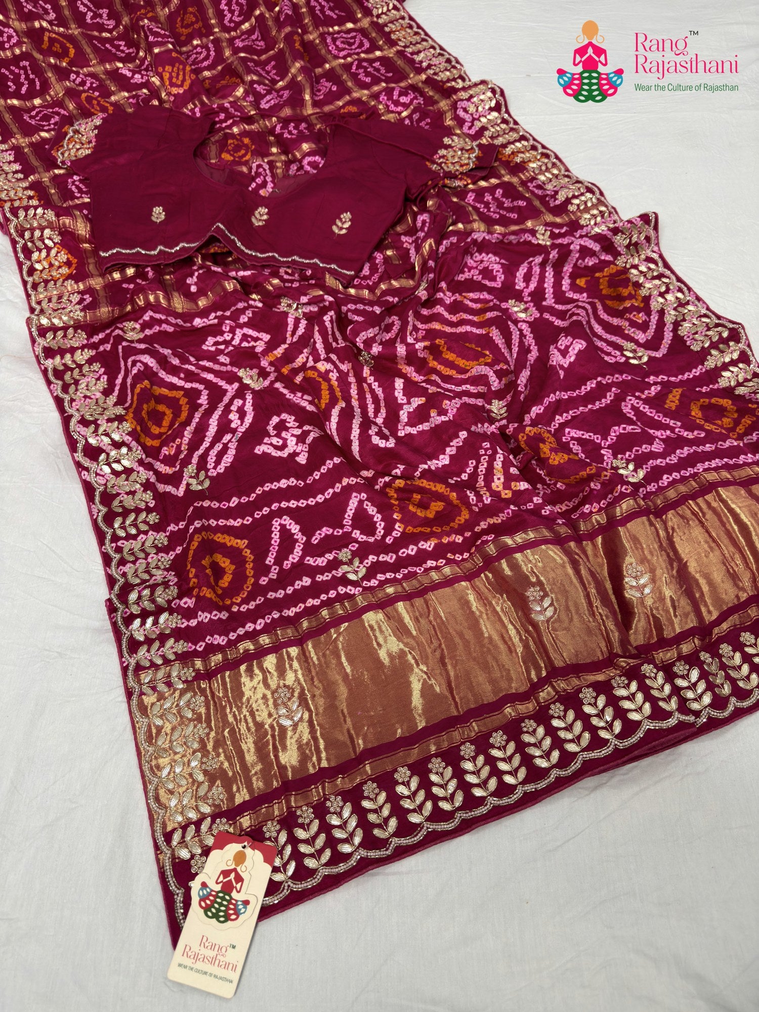 border detailing of soft red fabric saree
