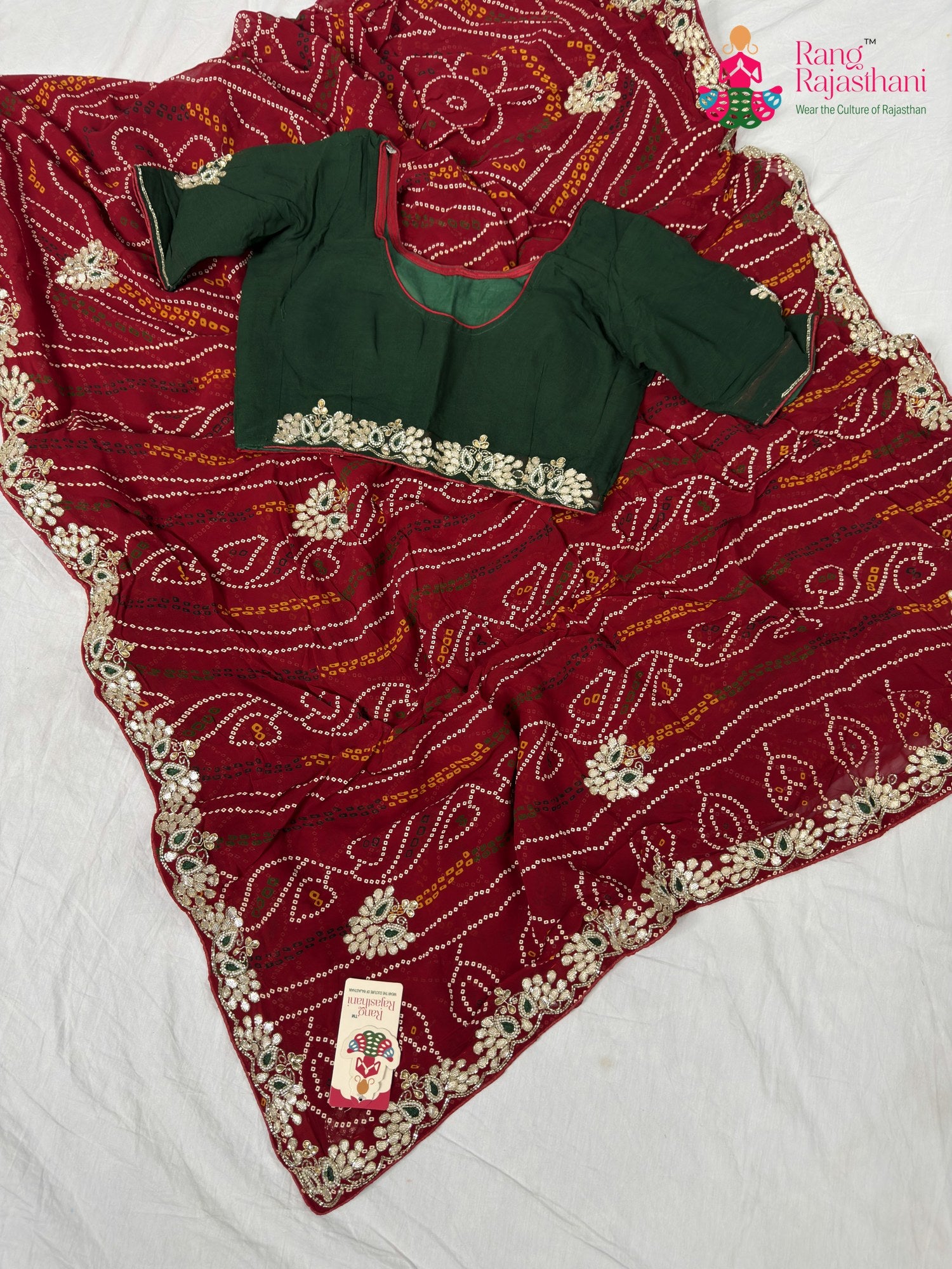 border detailing of soft red fabric saree