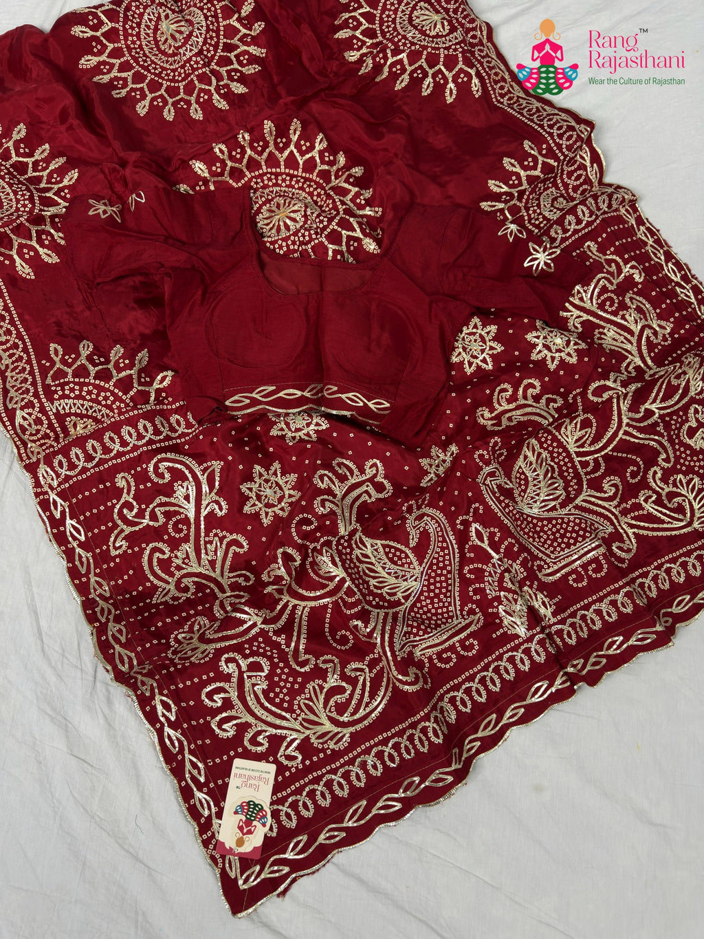 border detailing of soft red fabric saree