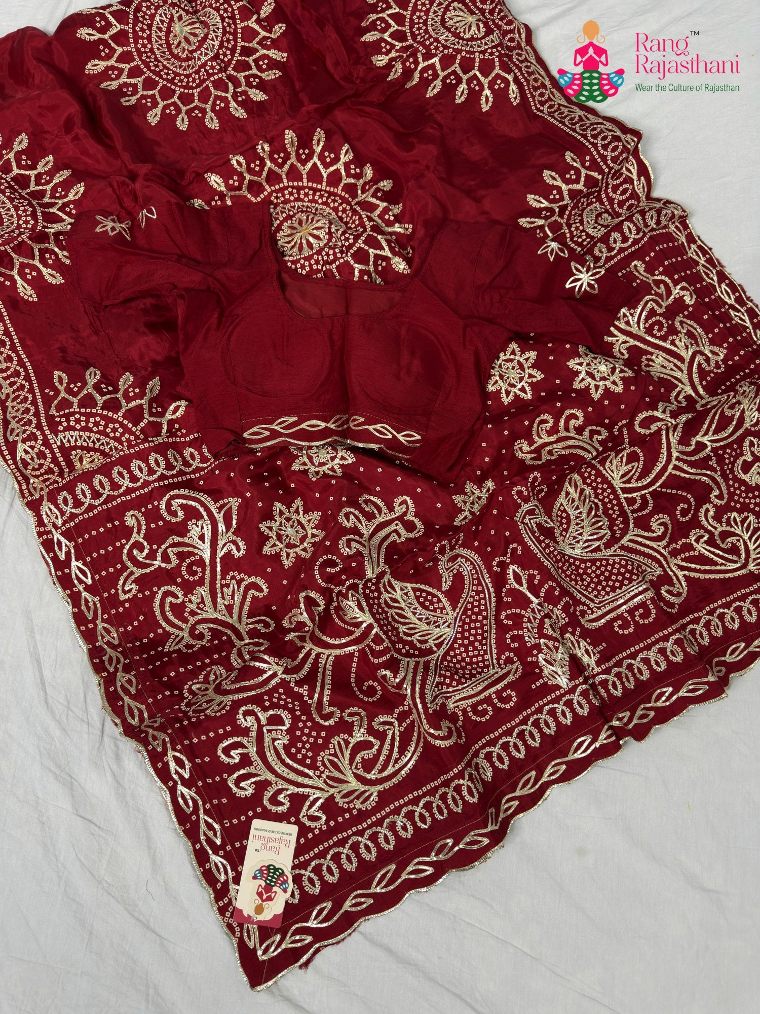 border detailing of soft red fabric saree