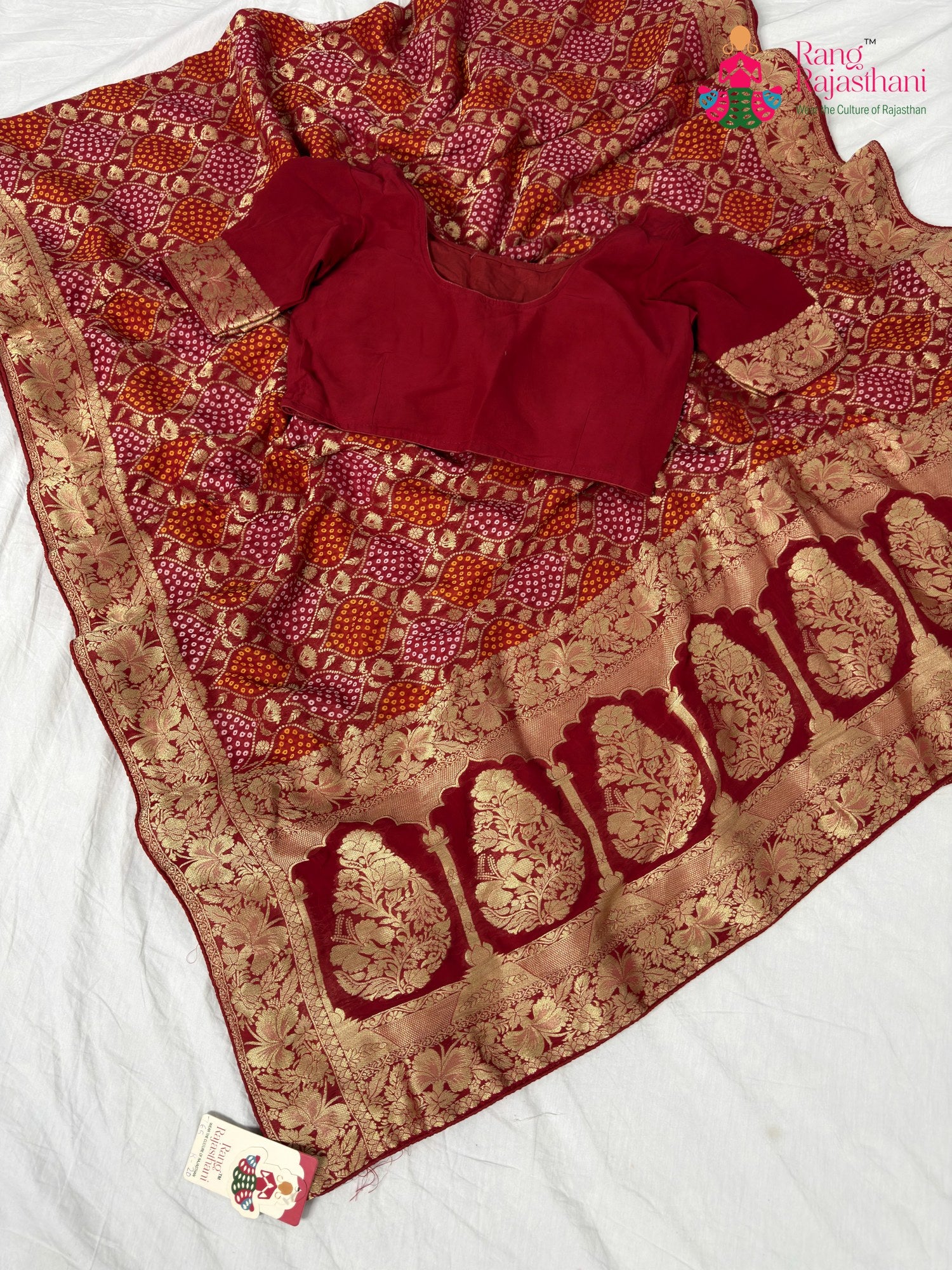 border detailing of soft red fabric saree