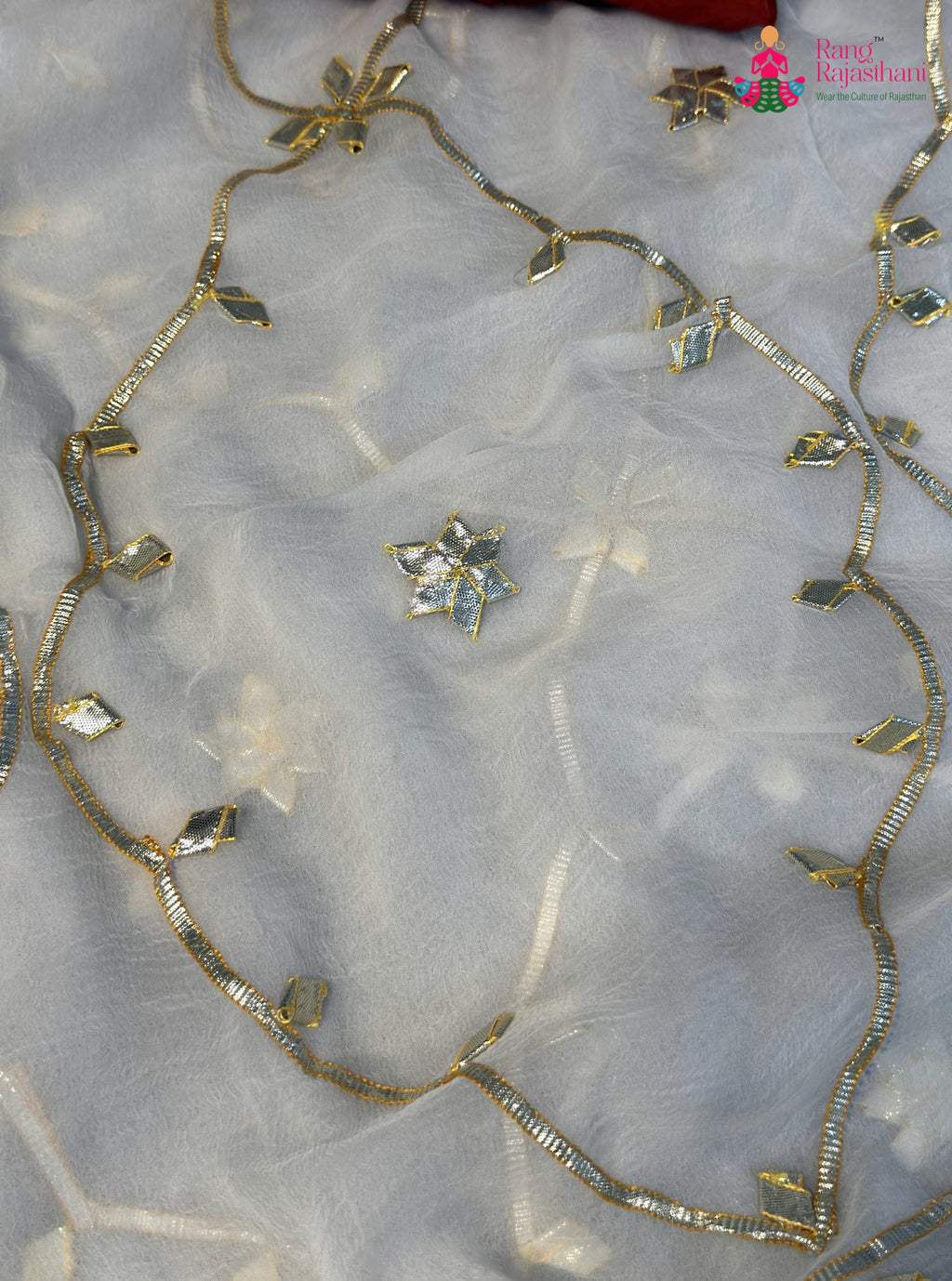 close up detailing of white chiffon gota patti saree