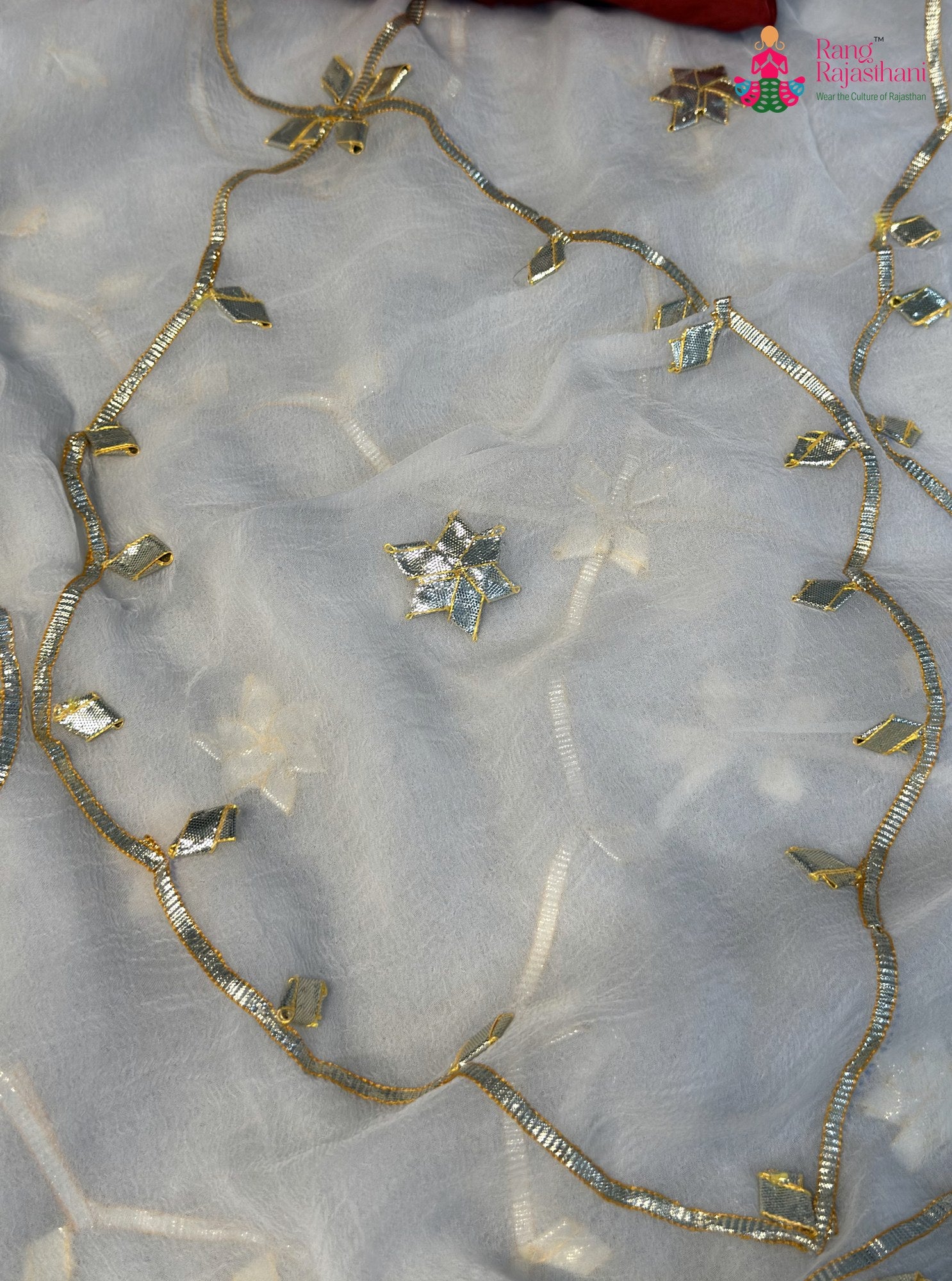 close up detailing of white chiffon gota patti saree