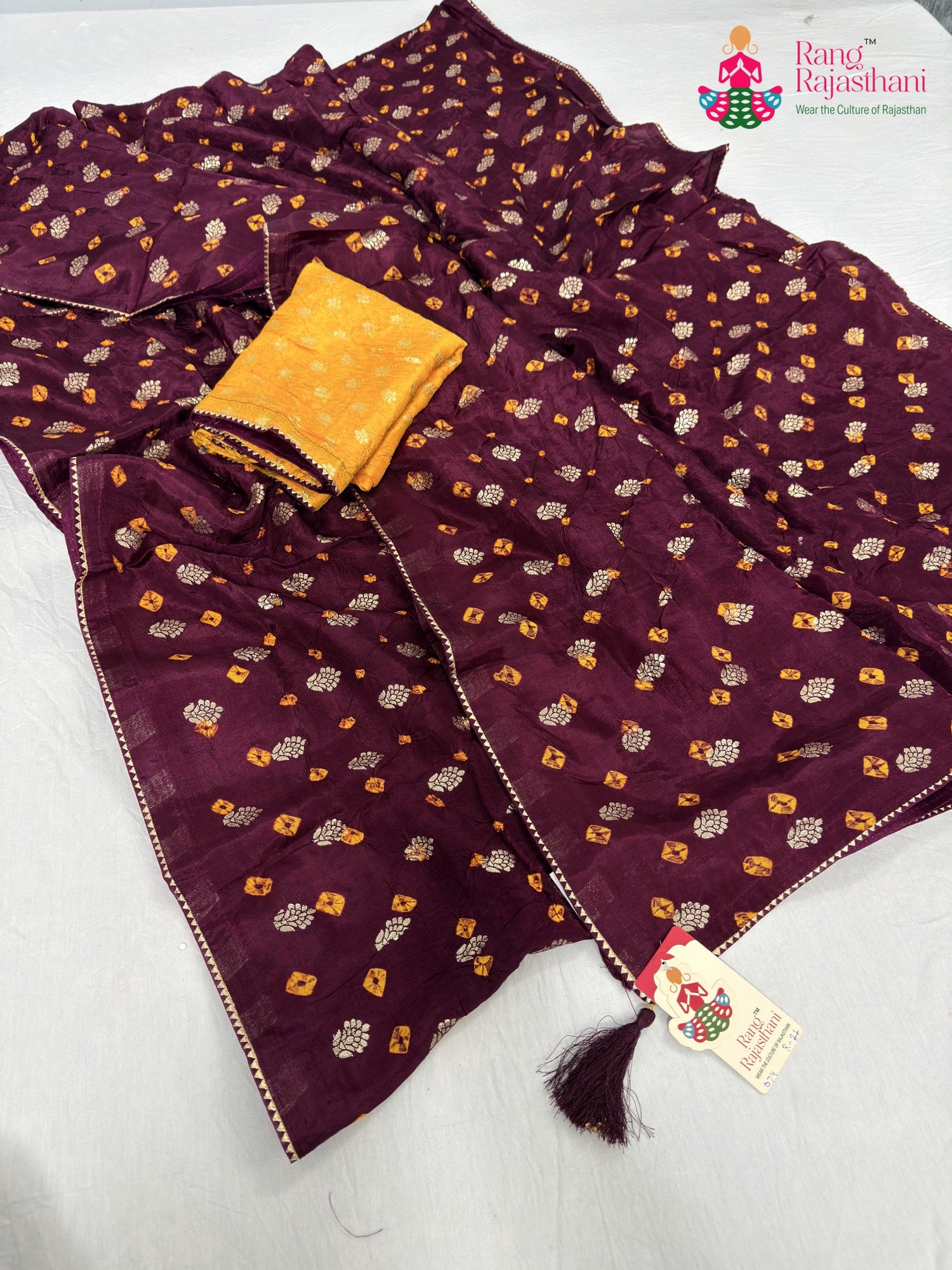 close up detailing of wine pure dola silk bandhani saree