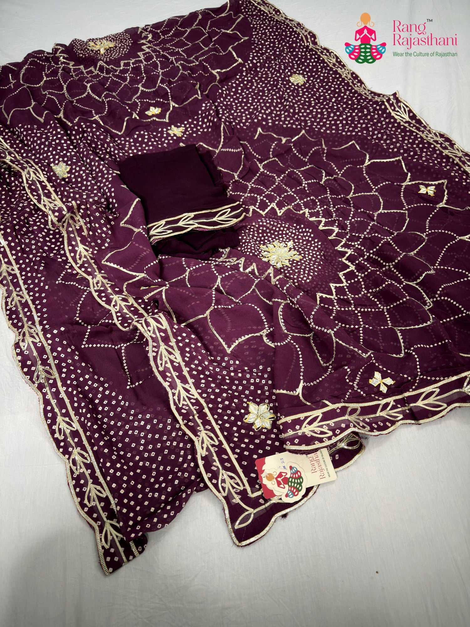 close up detailing of wine soft georgette bandhani saree
