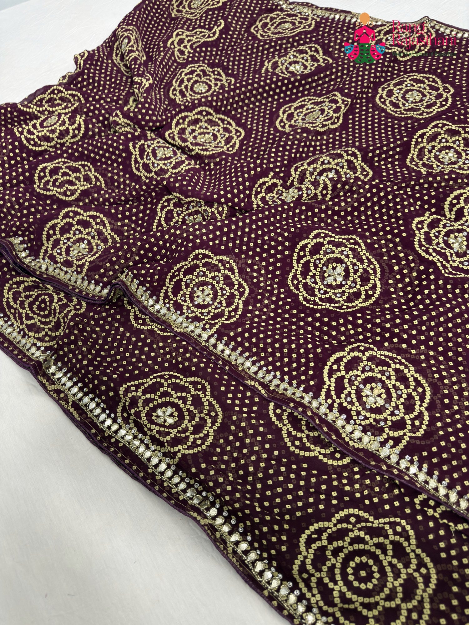 border detailing of wine synthetic bandhani saree