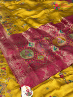 pallu detailing of yellow art silk meenakari zari saree