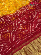 design pattern of yellow russian silk bandhani gharchola saree