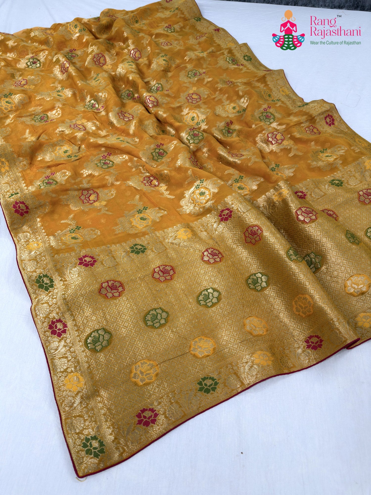 close up detailing of yellow soft georgette meenakari zari saree