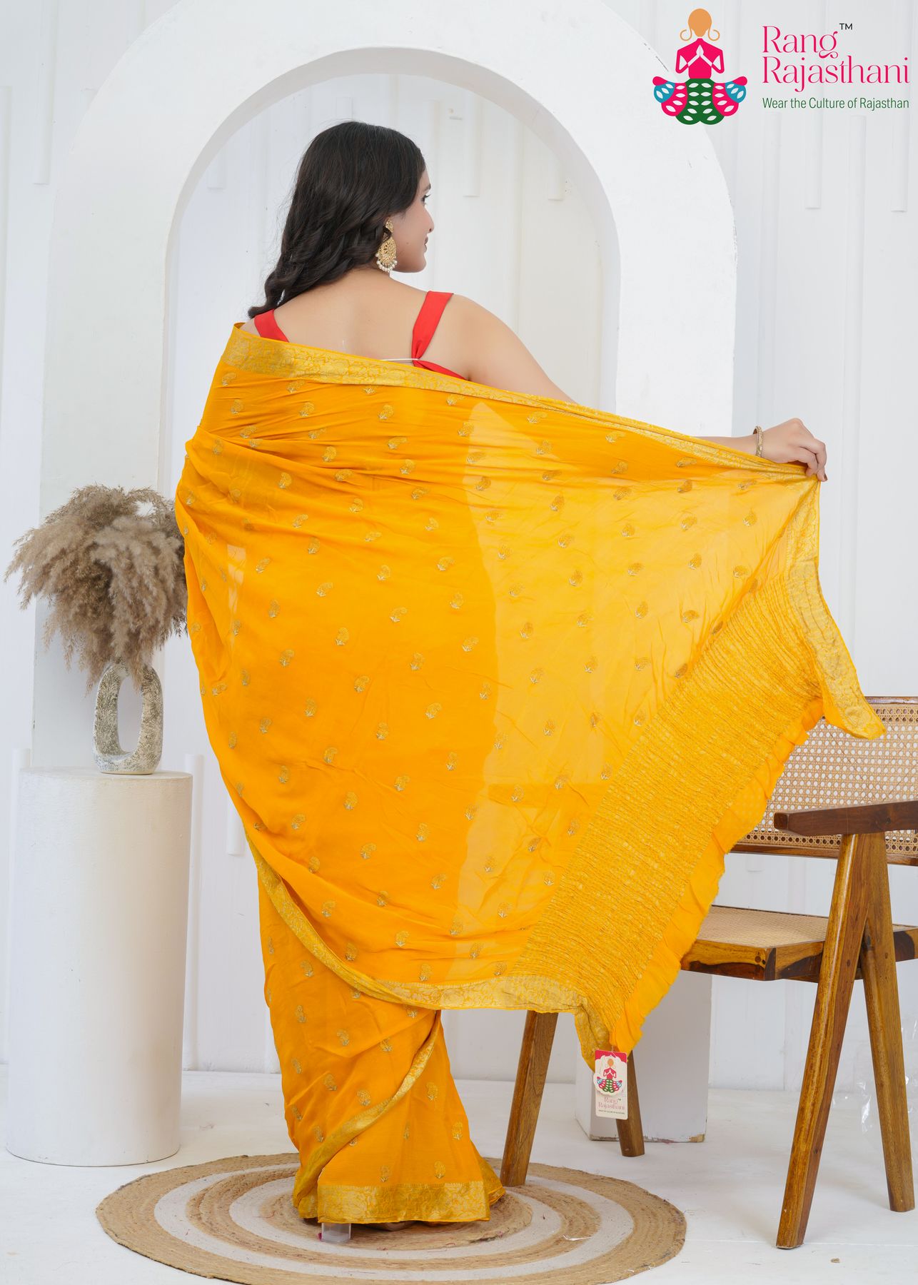 yellow chinnon saree with hand-embroidered buttis amp; banarasi zari border back view