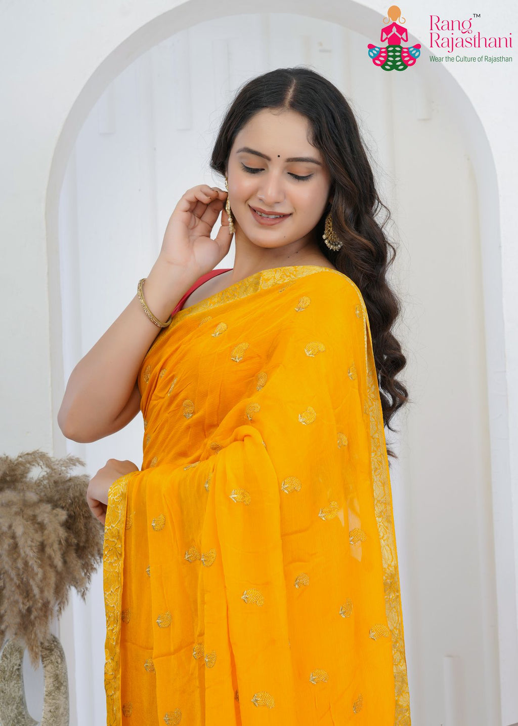 yellow chinnon saree with hand-embroidered buttis amp; banarasi zari border close-up view